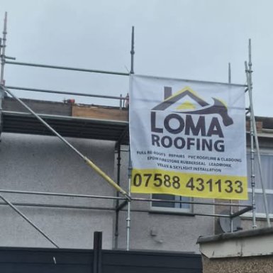 LOMA Roofing banner hanging on scaffolding at a job