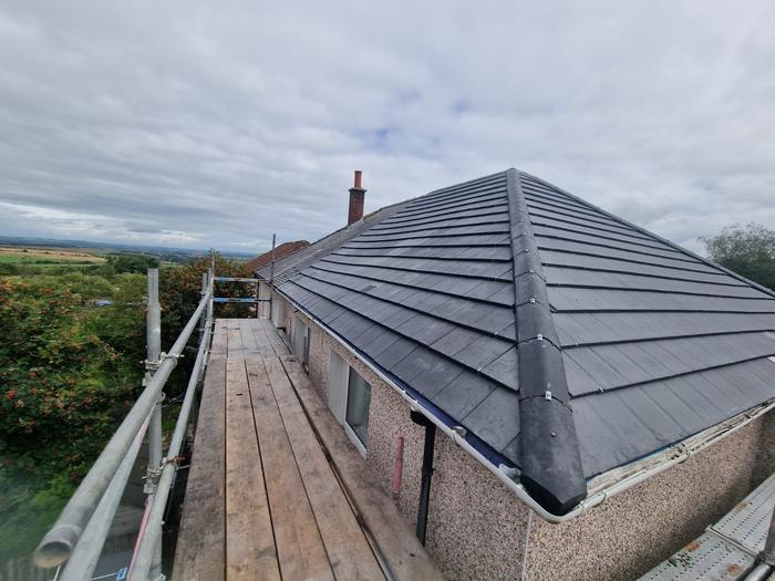 Finished grey tiled hip roof with dry-fix ridges